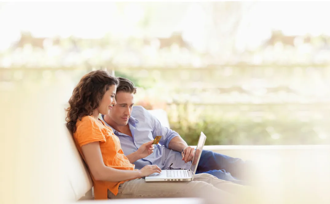 Hombre y mujer sentados viendo un computador 